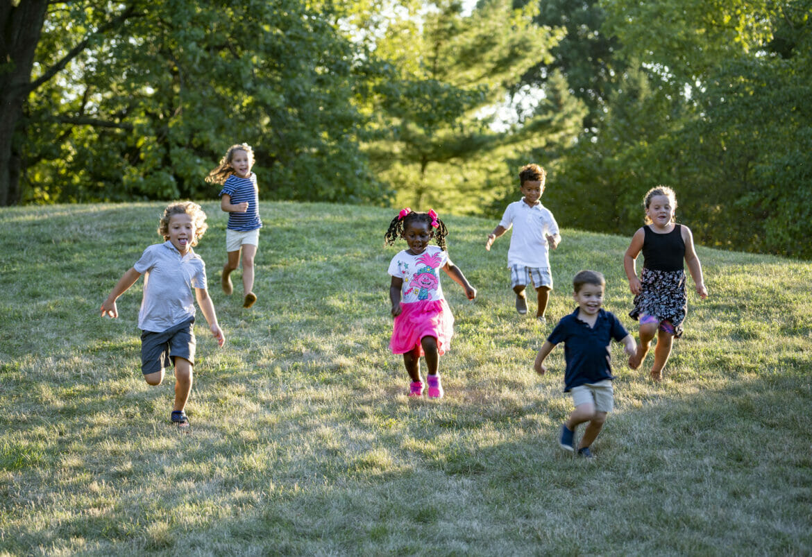 A group of kids running down a hill