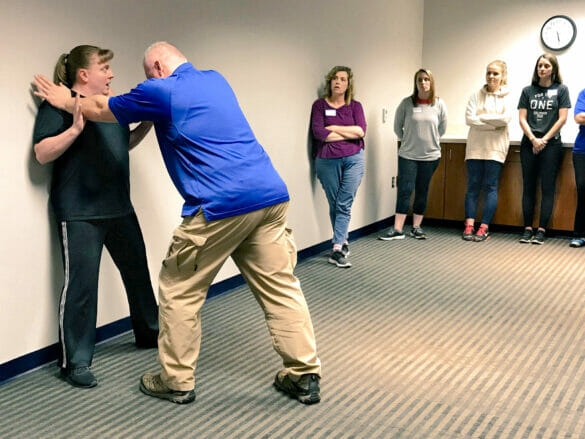 Police instructor teaching self-defense
