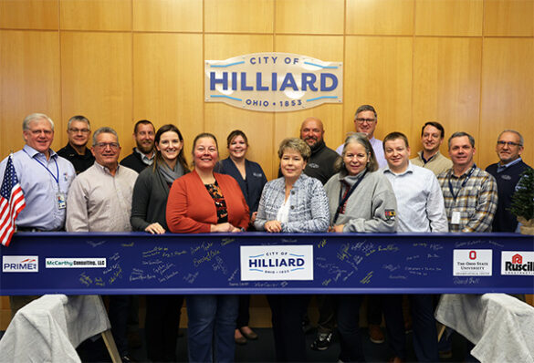 City leaders with beam